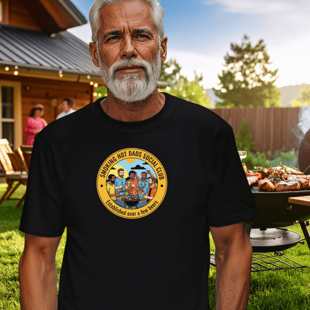 Man wearing a Smoking Hot Dads Social Club t-shirt in a BBQ backyard setting