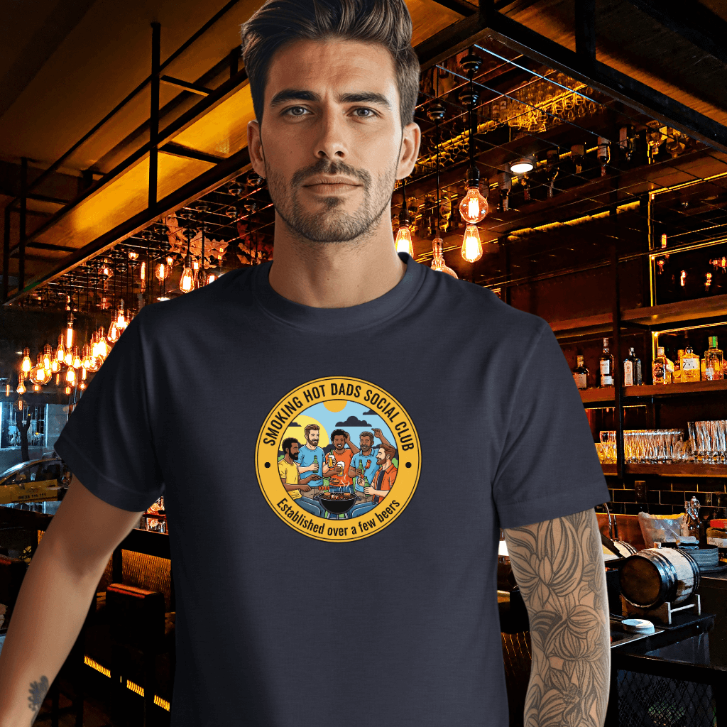 Man wearing a Smoking Hot Dads Social Club t-shirt in a bar setting