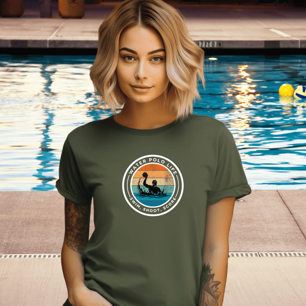 Woman wearing a green t-shirt with a 'Water Polo Life' graphic by a pool.